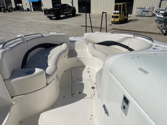 Slide: The Image of 2000 Chaparral Sunesta 232 boat interior with white seating and cup holders. - 9