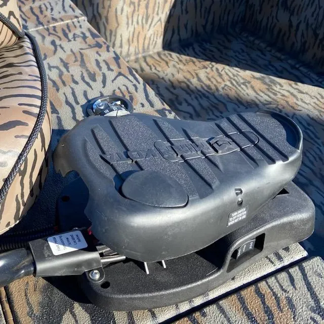 Slide: The Image of 2024 Xpress XP180 boat interior with camo seats and trolling motor pedal. - 10