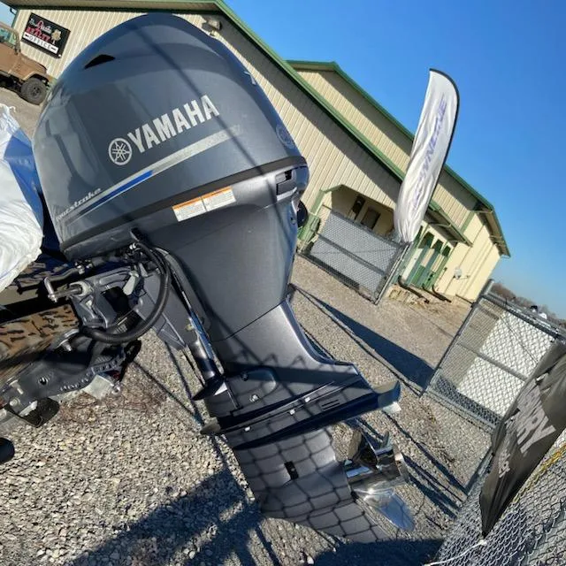Slide: The Image of 2024 Xpress XP180 boat with Yamaha outboard motor, displayed outdoors. - 2