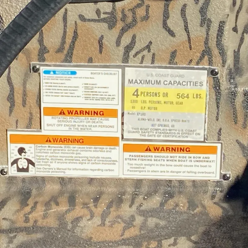 Slide: The Image of 2024 Xpress XP180 capacity and safety warning labels on a textured surface. - 5