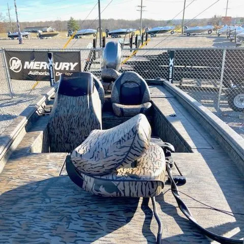 Slide: The Image of 2024 Xpress XP180 boat with camo seats at a Mercury dealer lot. - 7