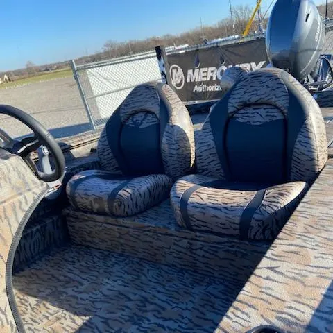 Slide: The Image of 2024 Xpress XP180 boat interior with camo seats and Mercury engine. - 8