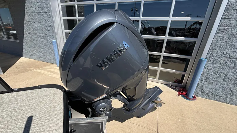 Slide: The Image of 2024 Tahoe Pontoon 2585 Cascade with Yamaha outboard motor, parked outdoors. - 10