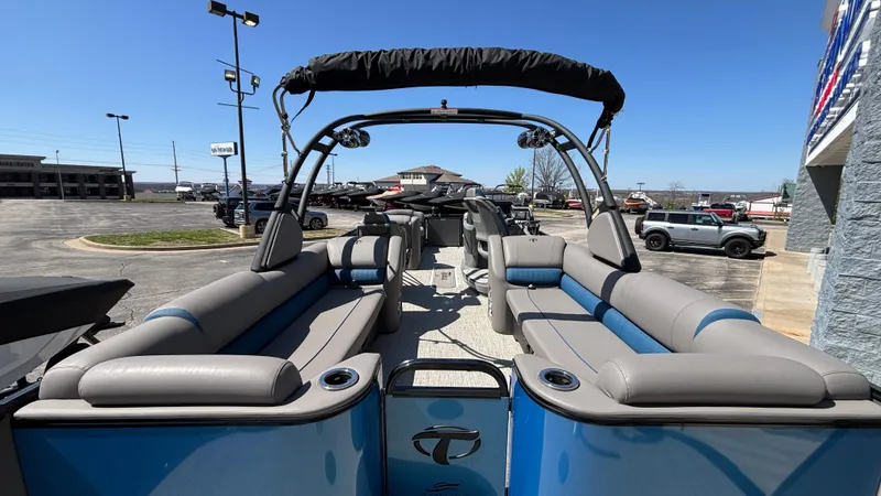 Slide: The Image of 2024 Tahoe Pontoon 2585 Cascade with spacious seating and sleek design in a parking lot. - 13