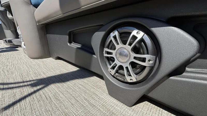 Slide: The Image of 2024 Tahoe Pontoon 2585 Cascade speaker detail on carpeted deck. - 14