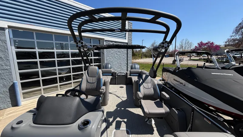 Slide: The Image of 2024 Tahoe Pontoon 2585 Cascade with sleek seating and modern design, parked outdoors. - 16