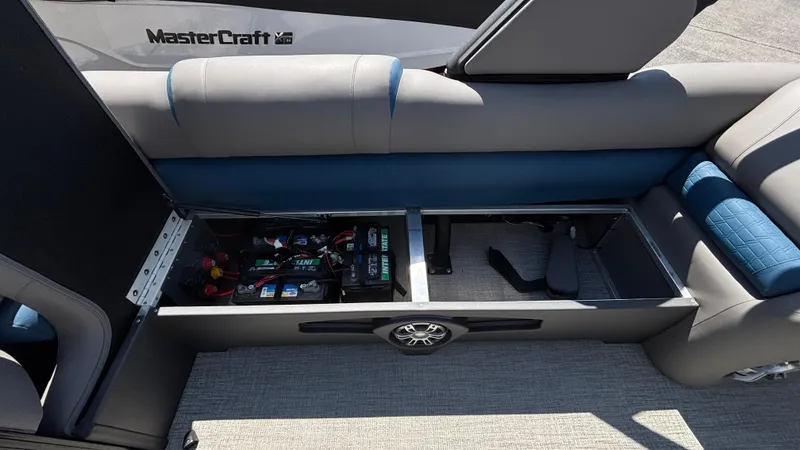 Slide: The Image of 2024 Tahoe Pontoon 2585 Cascade storage compartment with visible battery and wiring. - 28