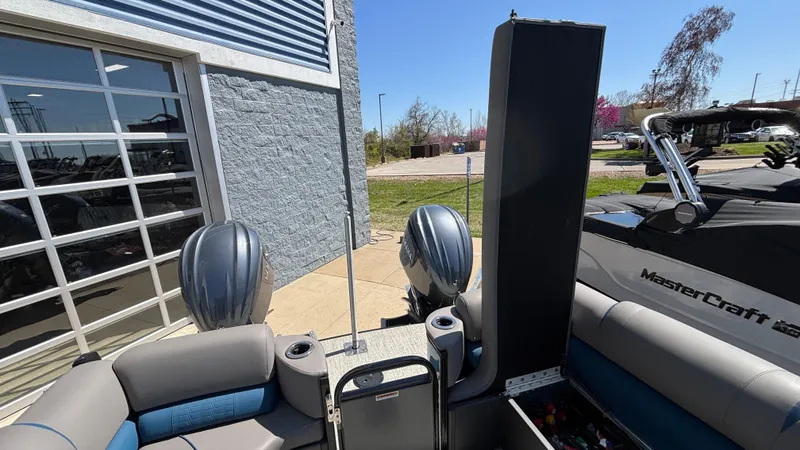 Slide: The Image of 2024 Tahoe Pontoon 2585 Cascade at a marina, showcasing seating and storage features. - 29