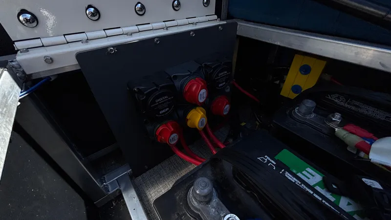 Slide: The Image of 2024 Tahoe Pontoon 2585 Cascade battery compartment with wiring and switches. - 30