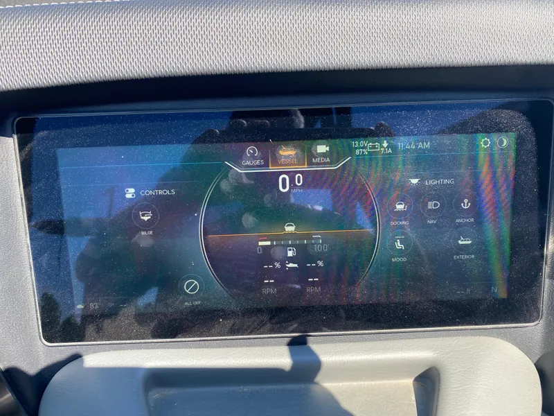 Slide: The Image of 2024 Tahoe 2585 Cascade dashboard display showing controls and gauges in bright sunlight. - 32