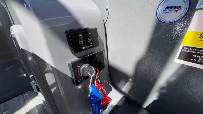 Slide: The Image of 2024 Tahoe Pontoon 2585 Cascade ignition panel with keys and control switches. - 36