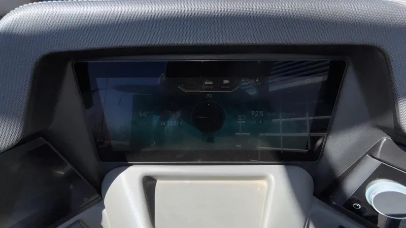 Slide: The Image of 2024 Tahoe Pontoon 2585 Cascade dashboard display with digital controls and navigation. - 37