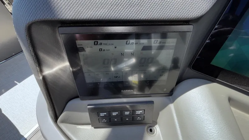 Slide: The Image of Dashboard of 2024 Tahoe Pontoon 2585 Cascade with Garmin display and control buttons. - 38