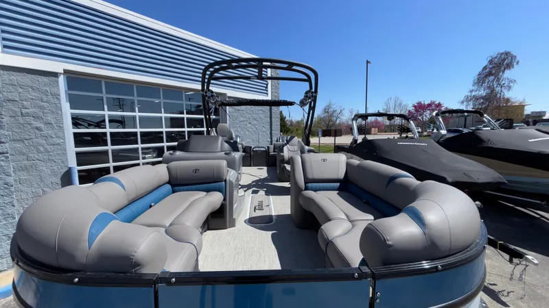 Slide: The Image of 2024 Tahoe Pontoon 2585 Cascade with spacious seating, displayed outdoors under clear skies. - 4