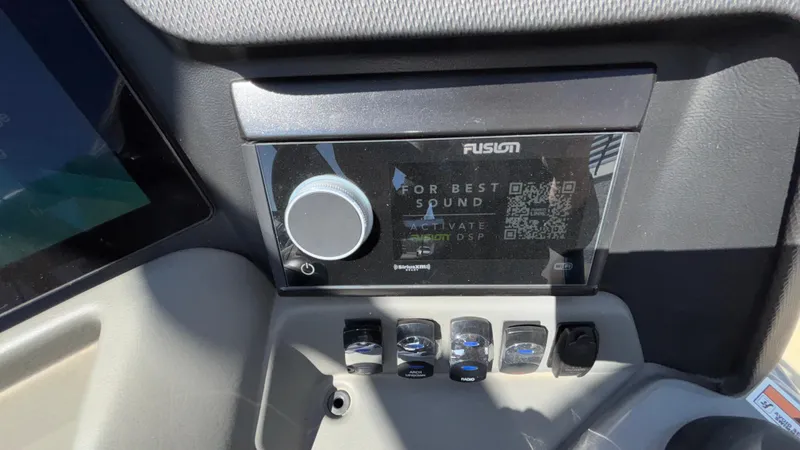 Slide: The Image of 2024 Tahoe Pontoon 2585 Cascade dashboard with Fusion sound system controls. - 41