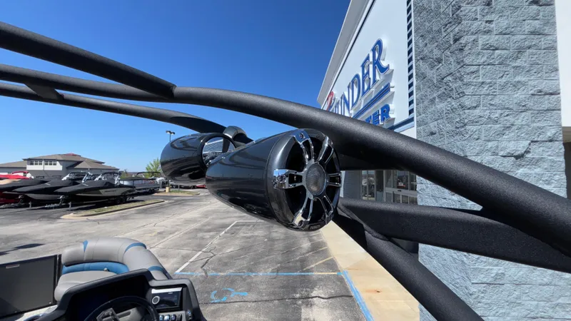 Slide: The Image of 2024 Tahoe Pontoon 2585 Cascade with sleek speakers, parked outside a dealership. - 45