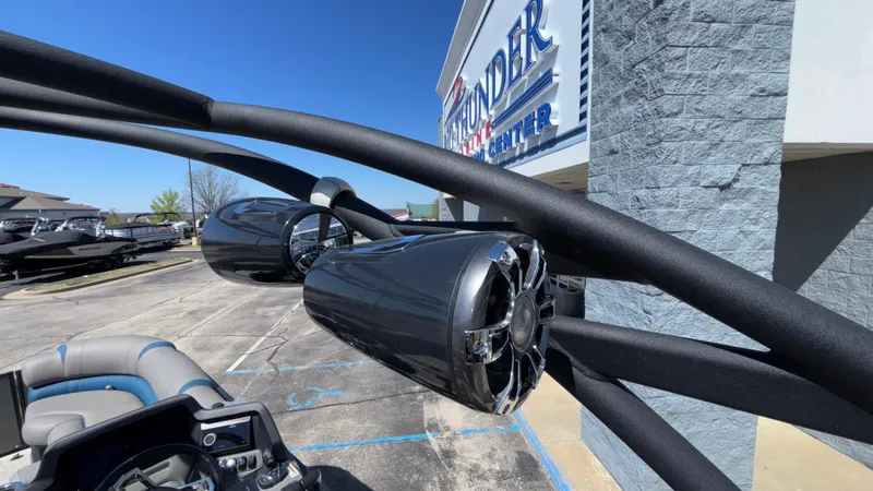 Slide: The Image of 2024 Tahoe Pontoon 2585 Cascade with sleek speakers at a dealership. - 46