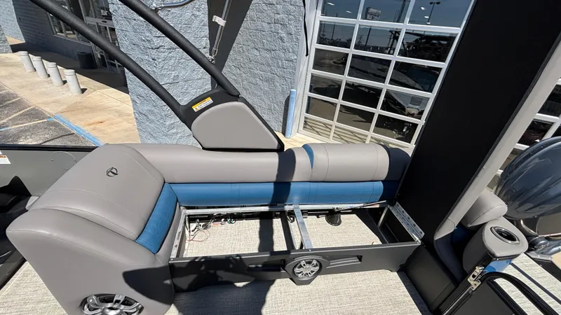 Slide: The Image of 2024 Tahoe Pontoon 2585 Cascade interior seating with modern design and blue-gray upholstery. - 6