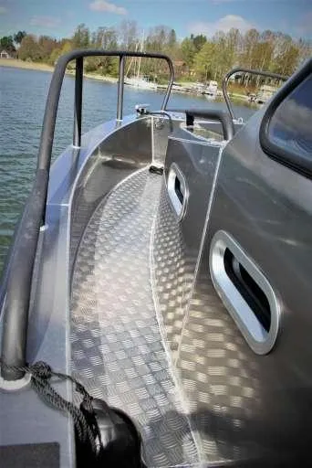 Slide: The Image of 2025 Alukin WA 950 boat with sleek aluminum deck design on a calm lake. - 3