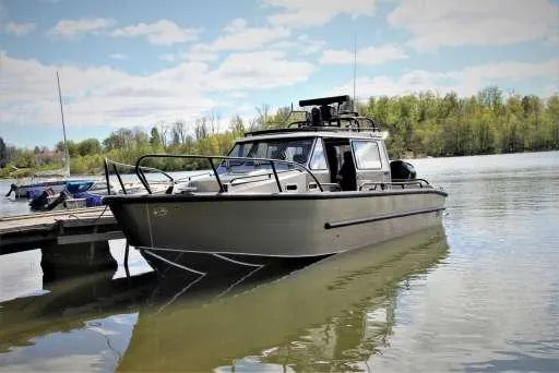 Slide: The Image of 2025 Alukin WA 950 boat docked on a calm lake under a clear sky. - 5