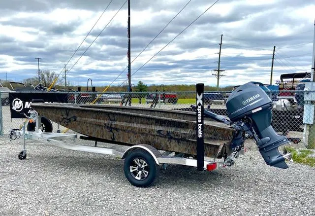 Slide: The Image of 2024 Express H16DB boat on trailer with Yamaha outboard motor, parked outdoors. - 1