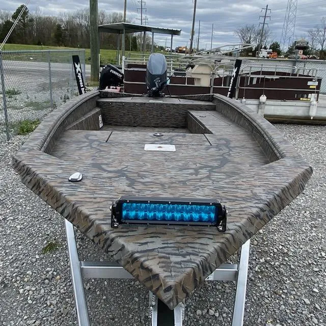 Slide: The Image of 2024 Express H16DB boat with camouflage design and blue LED light bar. - 4