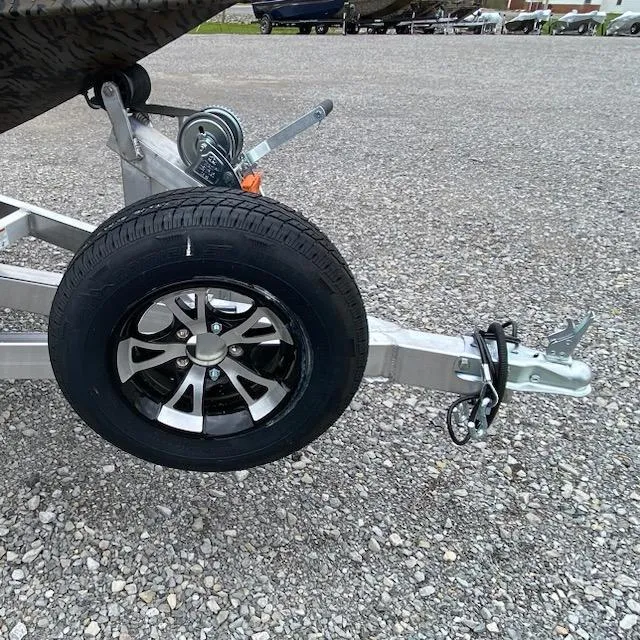 Slide: The Image of Trailer hitch and wheel of 2024 Express H16DB on gravel surface. - 5