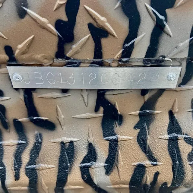 Slide: The Image of Camouflage-patterned metal surface with engraved code "JBC131206424," Express H16DB 2024 model. - 6