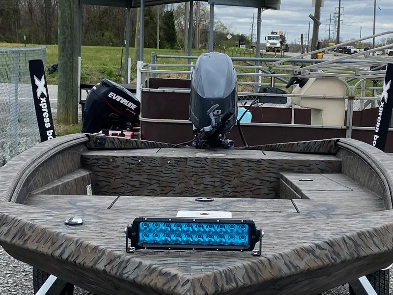 Slide: The Image of 2024 Express H16DB boat with camouflage design and blue LED light bar. - 8