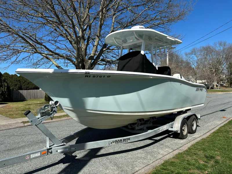 Slide: The Image of 2022 Sea Pro 239 Center Console boat on trailer, parked on a residential street. - 3