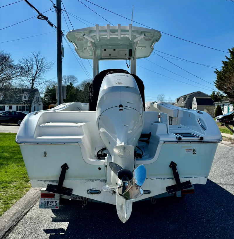 Slide: The Image of 2022 Sea Pro 239 Center Console boat, rear view, parked on a residential street. - 6