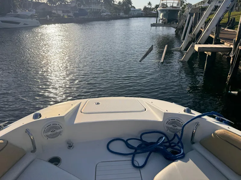Slide: The Image of 2011 Sea Ray 280 Sundeck boat on calm water, with blue rope on deck. - 12