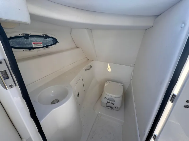 Slide: The Image of 2011 Sea Ray 280 Sundeck interior with compact bathroom and sink. - 8