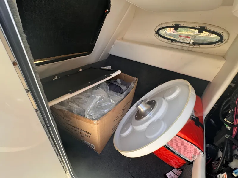 Slide: The Image of Interior cabin of 2011 Sea Ray 280 Sundeck with storage box and life preserver. - 9