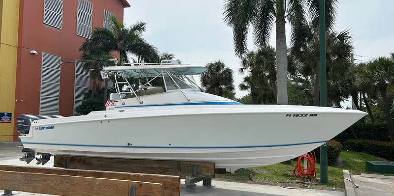 Slide: The Image of 2007 Contender 36 Fish Around boat on display near palm trees and building. - 3