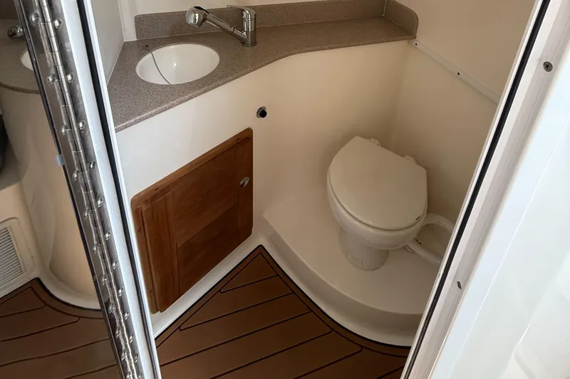 Slide: The Image of 2007 Contender 36 Fish Around boat bathroom with sink, toilet, and wooden cabinet. - 8