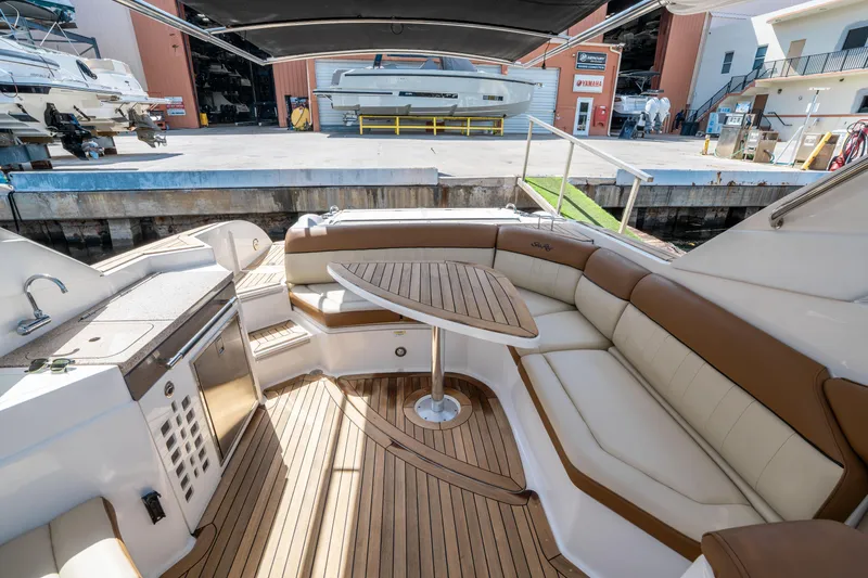 Slide: The Image of 2015 Sea Ray 350 SLX boat interior with luxurious seating and wooden deck. - 14