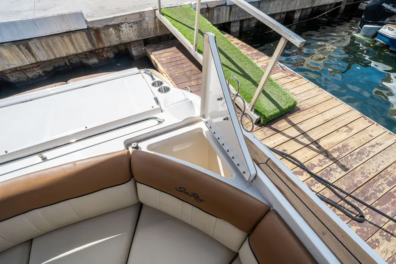 Slide: The Image of 2015 Sea Ray 350 SLX boat with open storage compartment at dockside. - 18