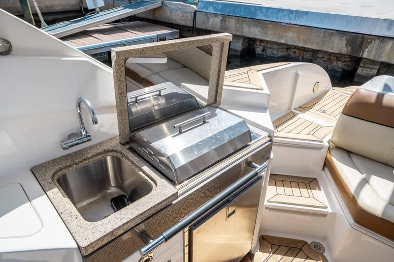 Slide: The Image of 2015 Sea Ray 350 SLX boat with outdoor kitchen and sink. - 23
