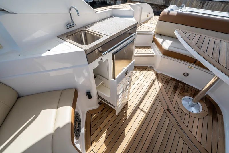 Slide: The Image of Luxurious 2015 Sea Ray 350 SLX boat interior with kitchenette and seating area. - 24