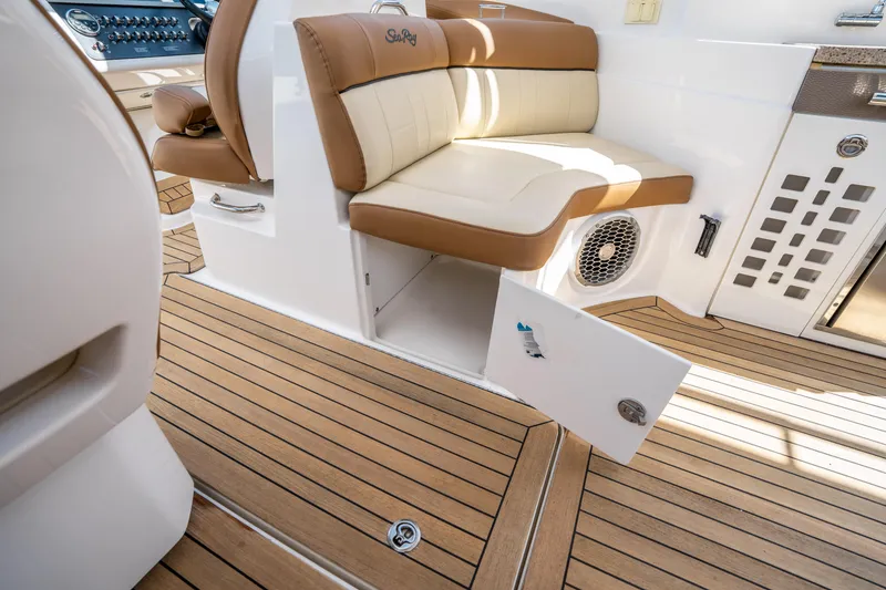 Slide: The Image of 2015 Sea Ray 350 SLX interior with tan seating and wood flooring. - 26