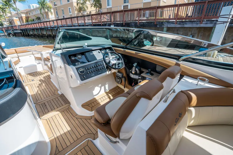Slide: The Image of 2015 Sea Ray 350 SLX boat interior with modern dashboard and seating. - 28