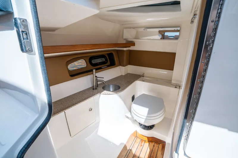 Slide: The Image of 2015 Sea Ray 350 SLX boat interior with modern bathroom, featuring sink and toilet. - 37