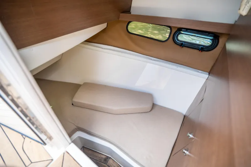 Slide: The Image of 2015 Sea Ray 350 SLX cabin interior with cozy bed and window view. - 40