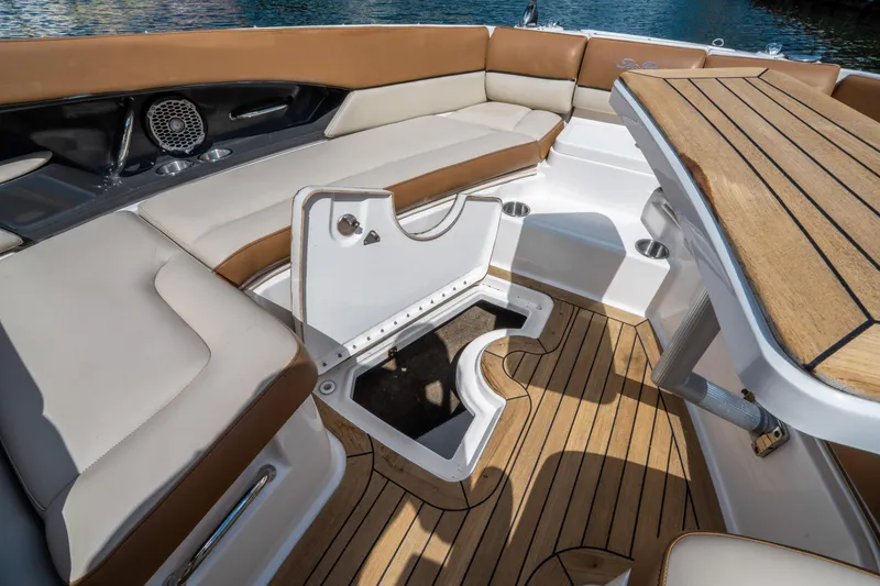 Slide: The Image of 2015 Sea Ray 350 SLX boat interior with teak flooring and cushioned seating. - 44
