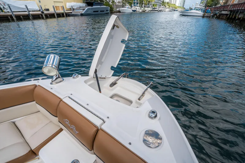 Slide: The Image of 2015 Sea Ray 350 SLX boat on water, open storage compartment, luxurious seating. - 46