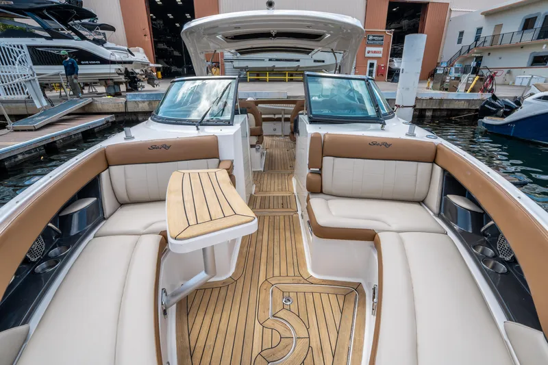 Slide: The Image of 2015 Sea Ray 350 SLX boat interior with luxurious seating and wooden flooring at a marina. - 47