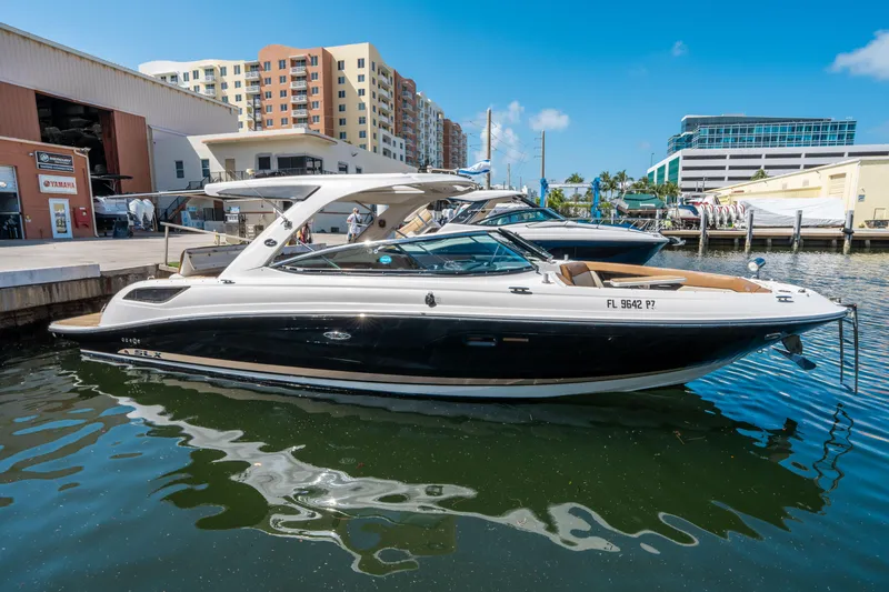 Slide: The Image of 2015 Sea Ray 350 SLX boat docked in marina, sunny day, urban background. - 6
