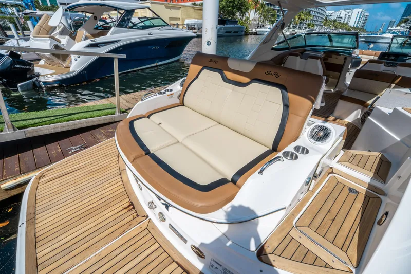 Slide: The Image of 2015 Sea Ray 350 SLX luxury boat with spacious seating and elegant design at marina. - 9