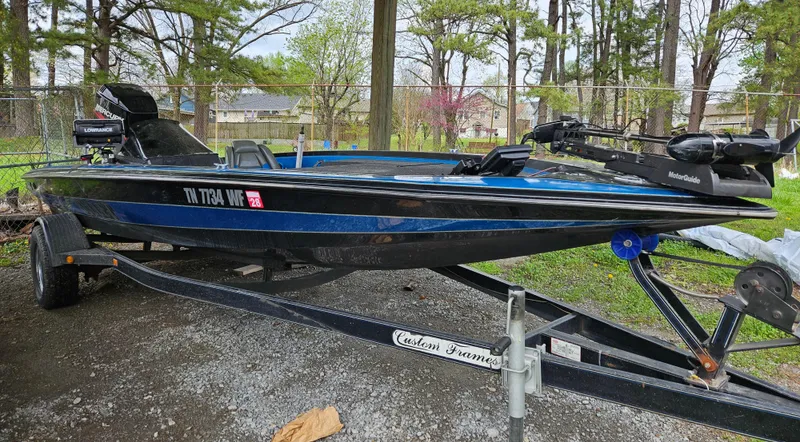 Slide: The Image of 1993 Bullet 20XD boat on trailer, parked outdoors, surrounded by trees. - 1